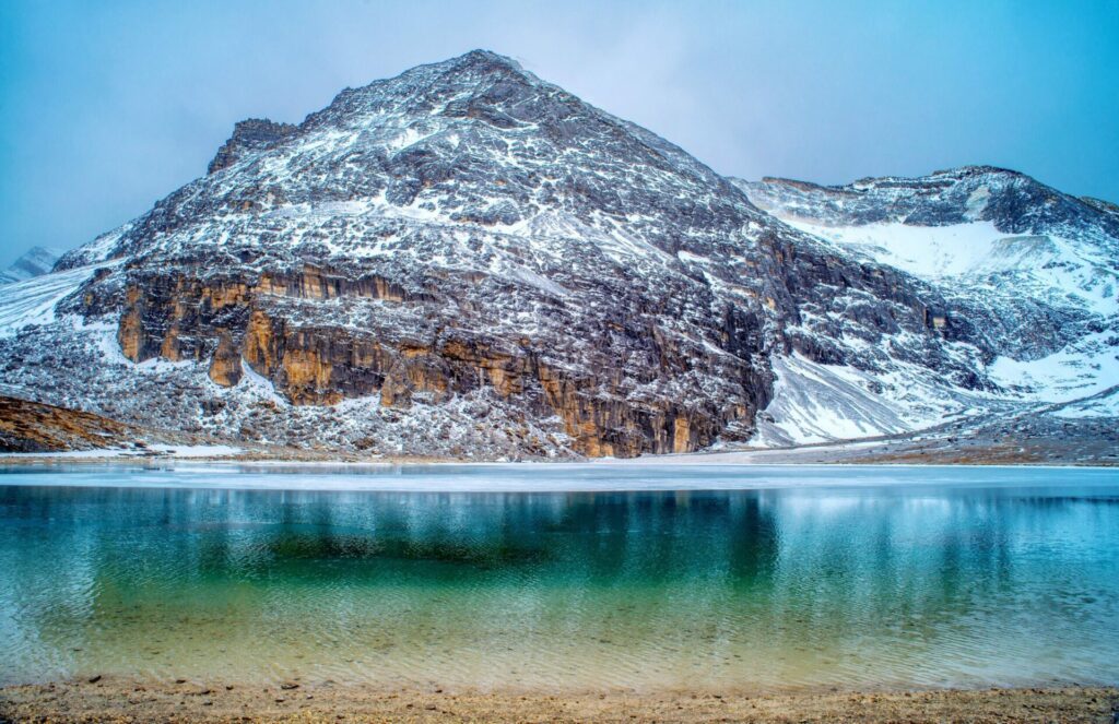 Nature landscape,Unique colored Milk lake (approx. 4300m altitude) with blue sky and sharp mountains around it in Daocheng Yading Nature Reserve, Sichuan, China